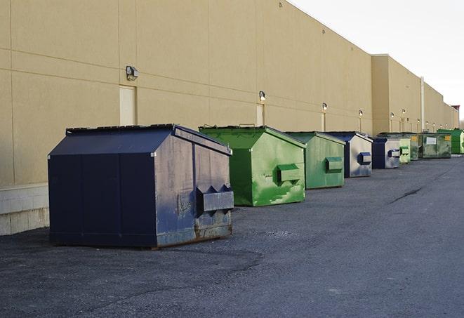 brightly colored dumpsters filled with construction waste in Glasgow